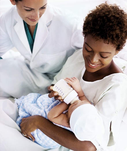 mother feeding baby milk using milk bottle