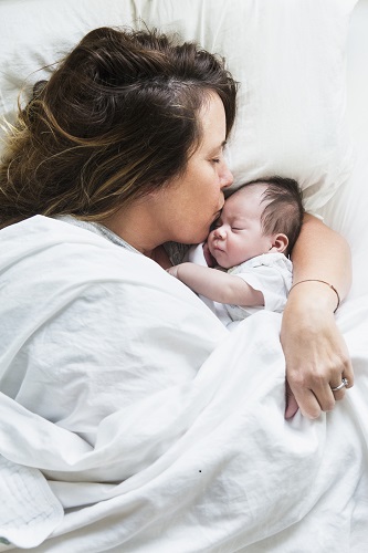 mother hugging baby to sleep