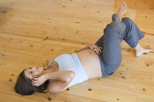 woman lying down and on the phone